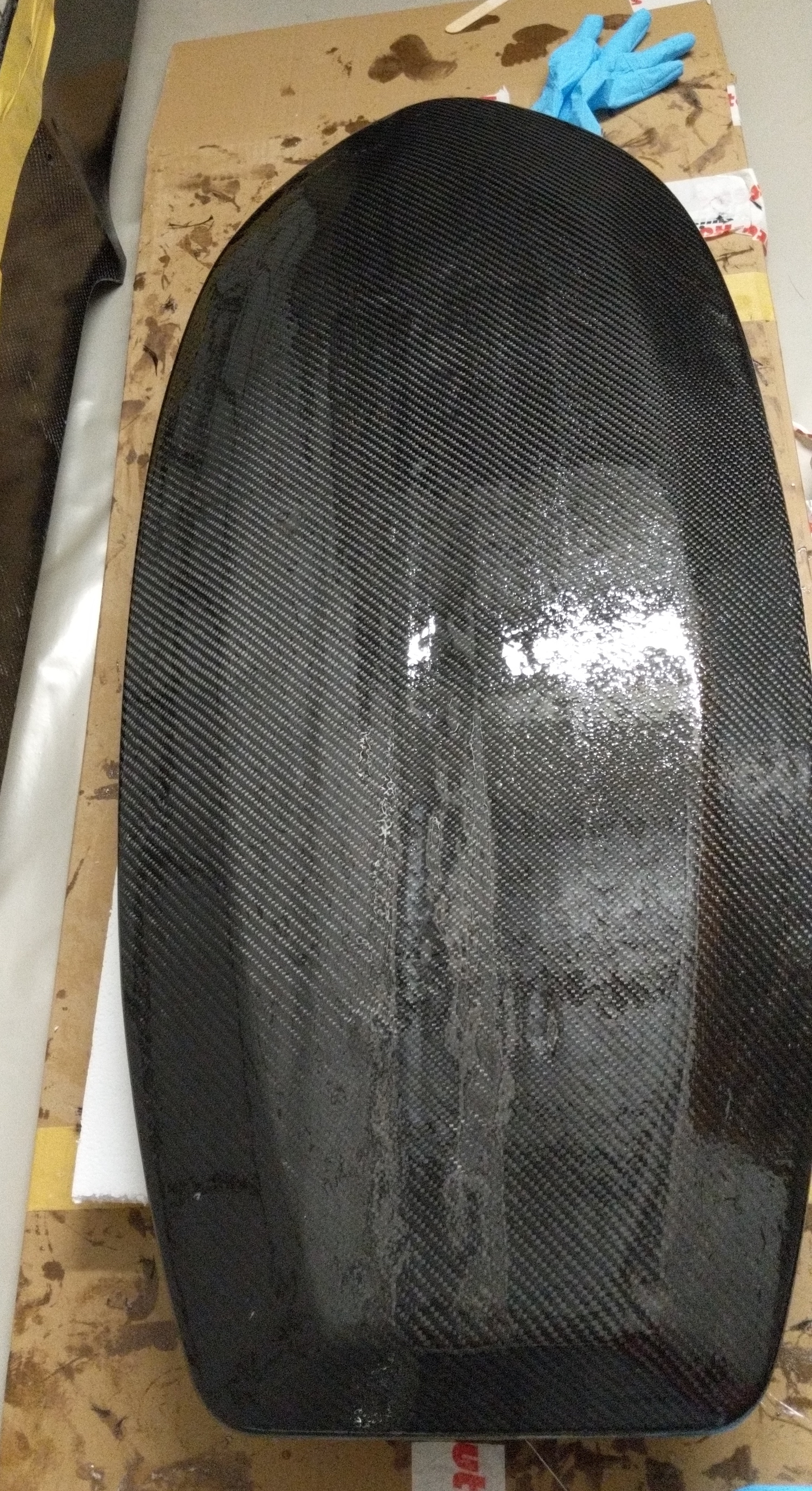 Carbon layer laminated to bottom of board.